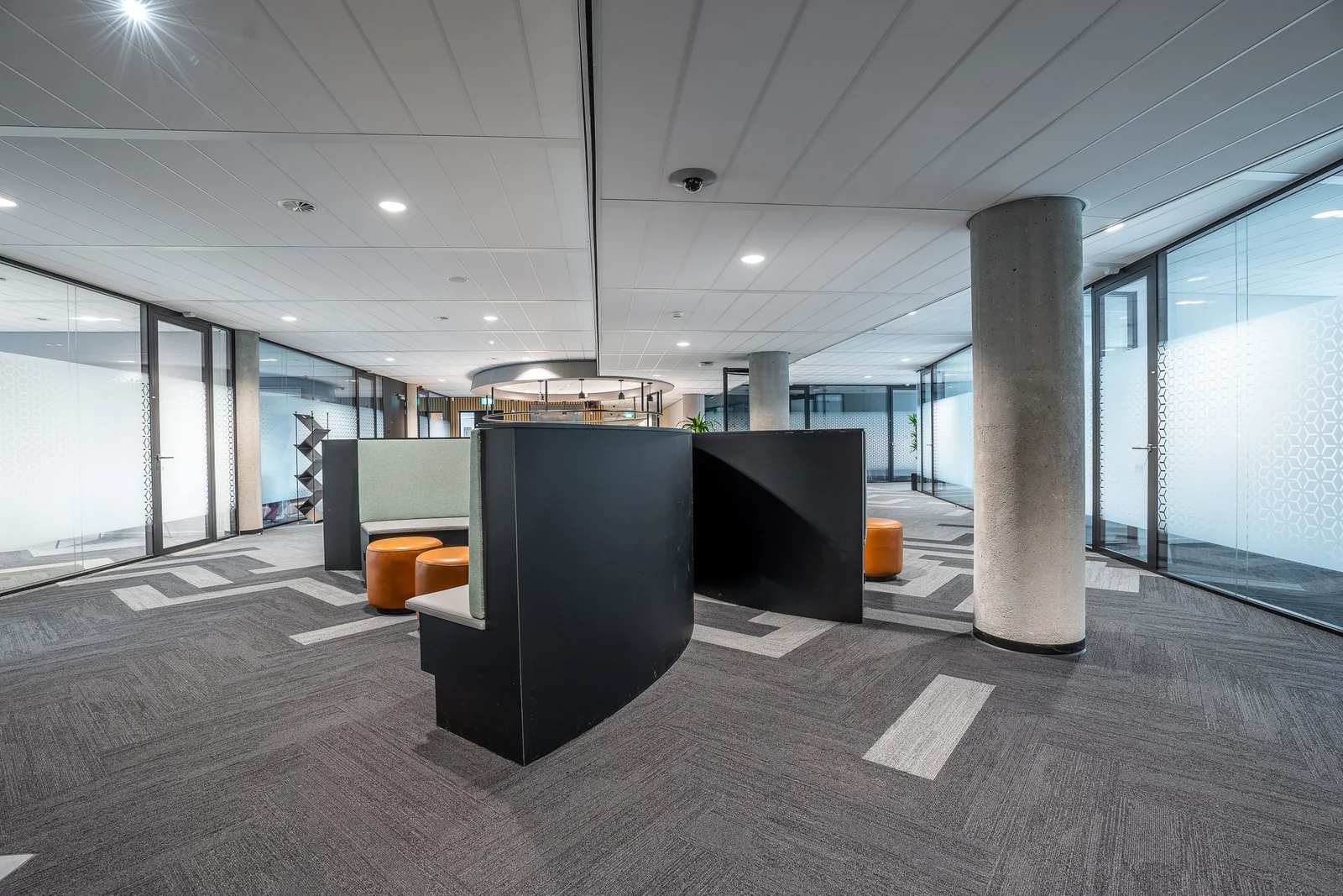 An open-plan office with frosted privacy film on its glass walls