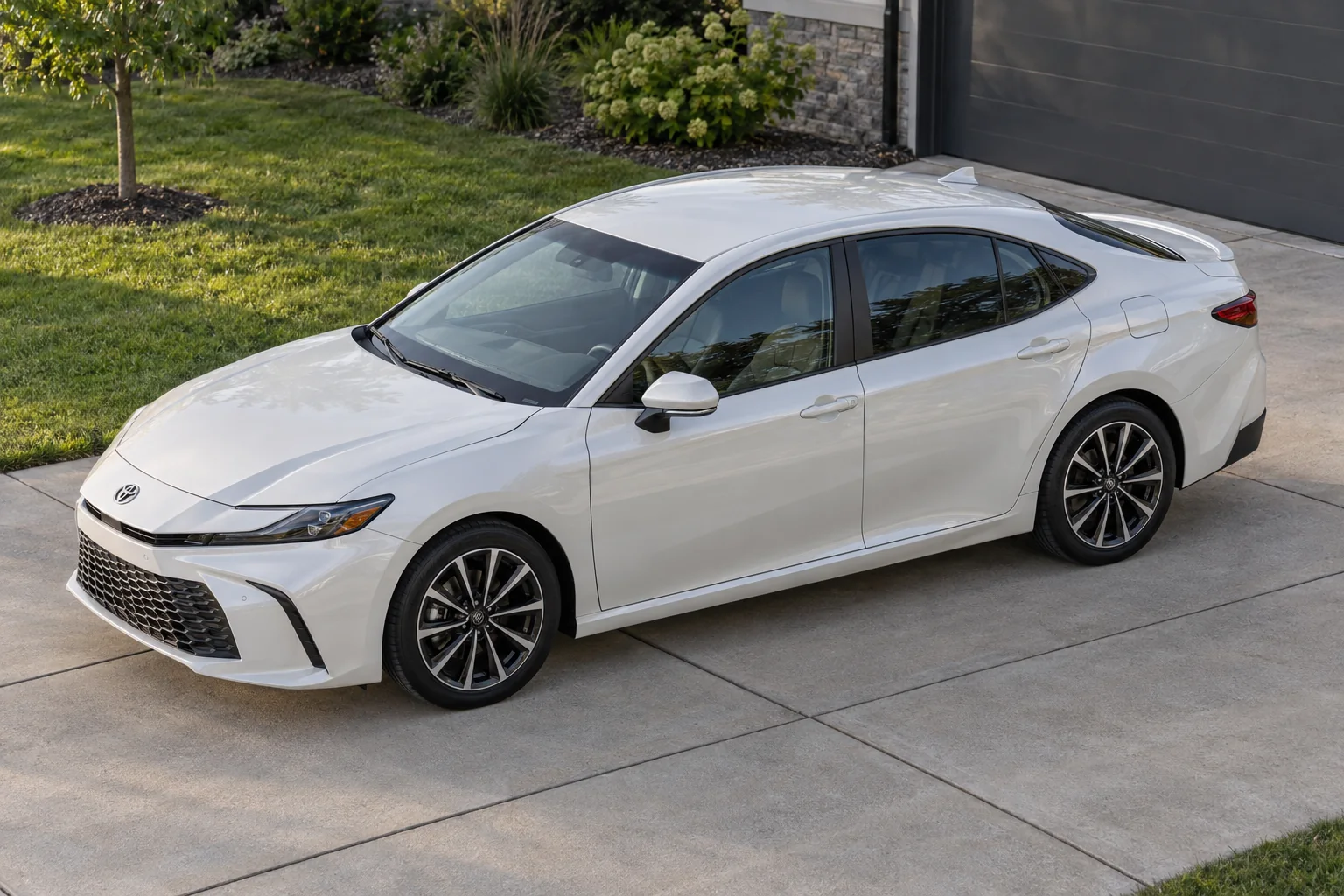 A white Toyota Camry seen from the side, each window tinted to the darkest shade Wisconsin allows