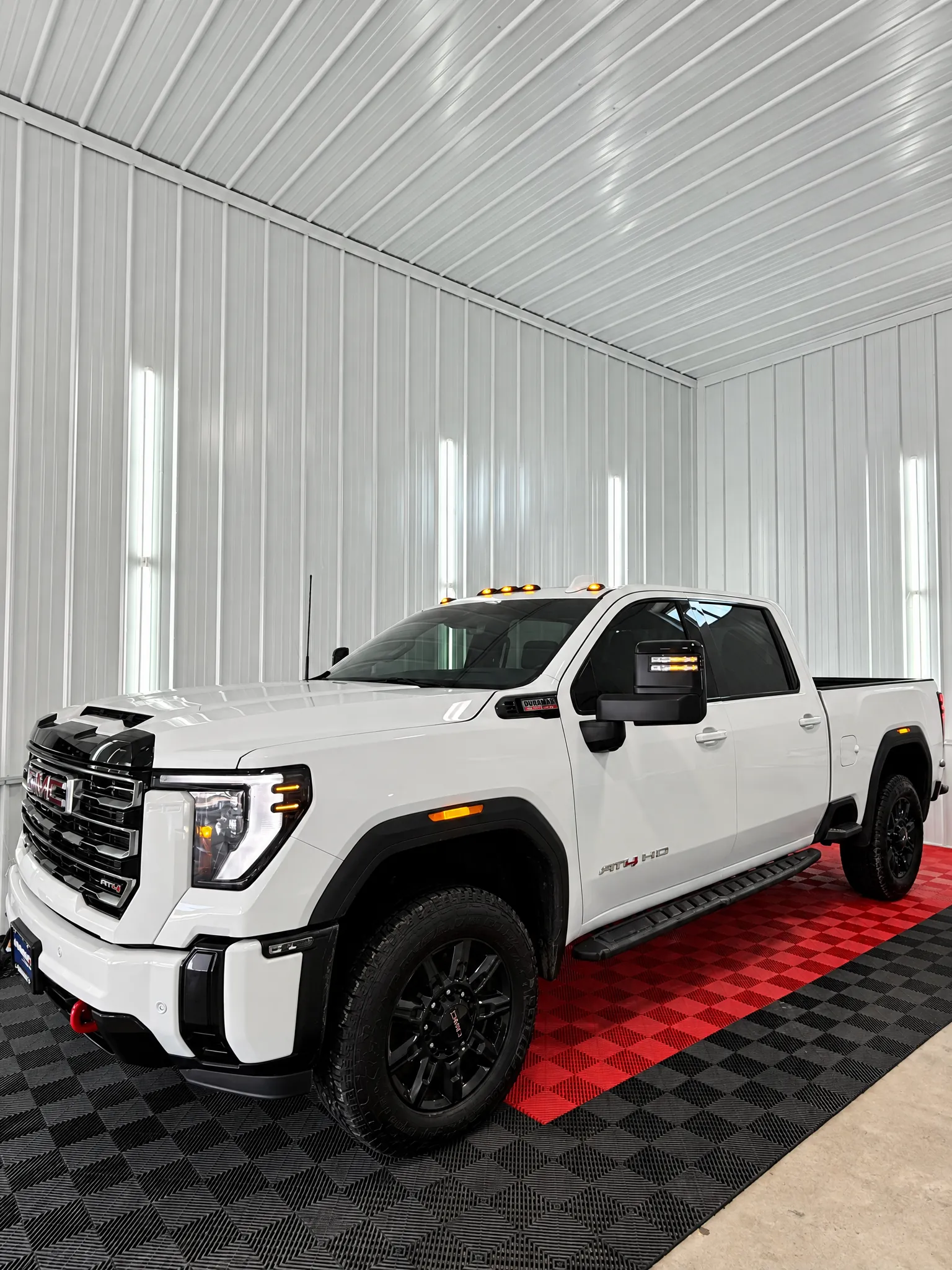 White GMC Sierra HD with tinted windows in the OnPoint Tintz bay