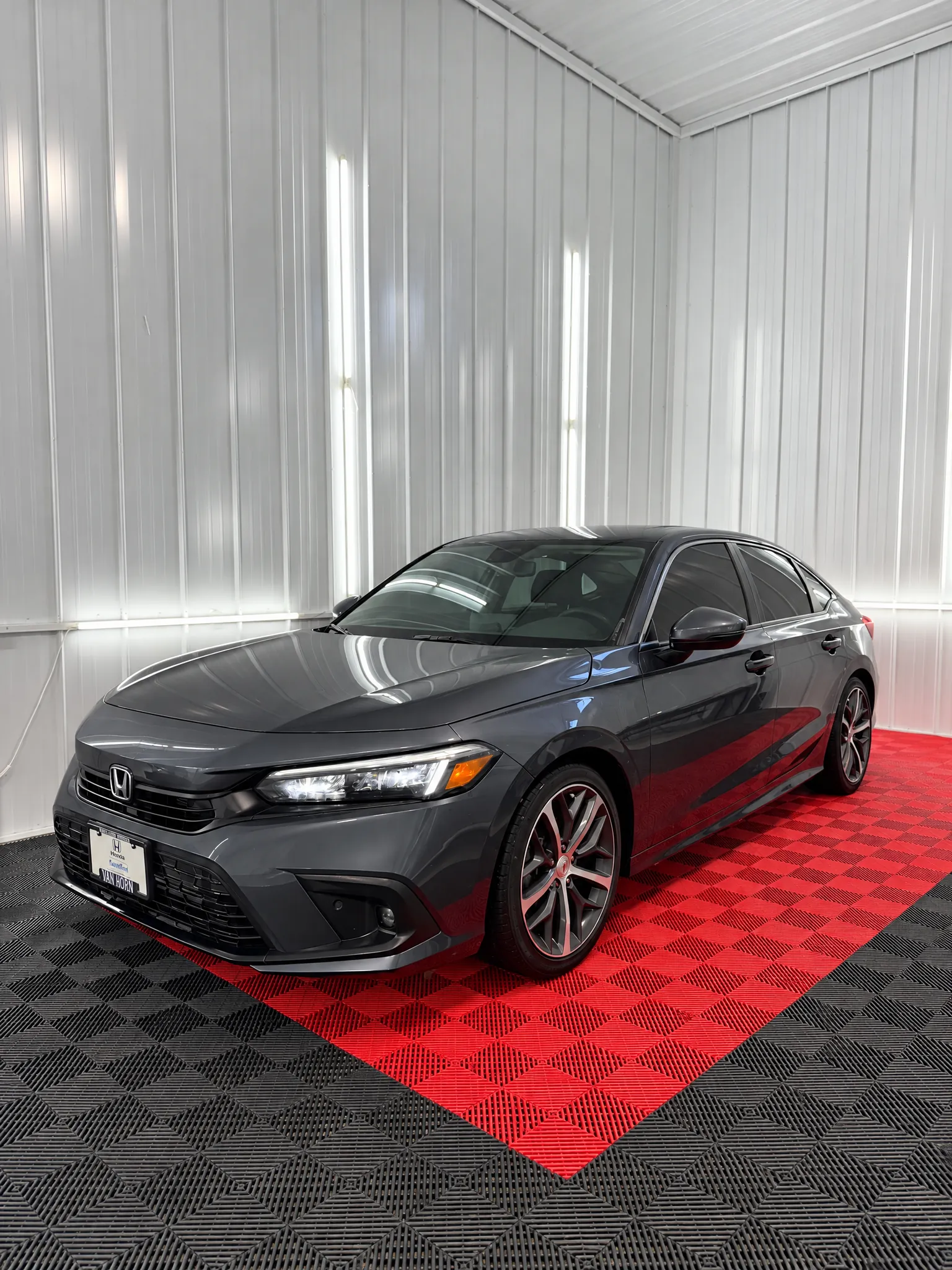 Dark gray Honda Civic with tinted windows in the OnPoint Tintz bay