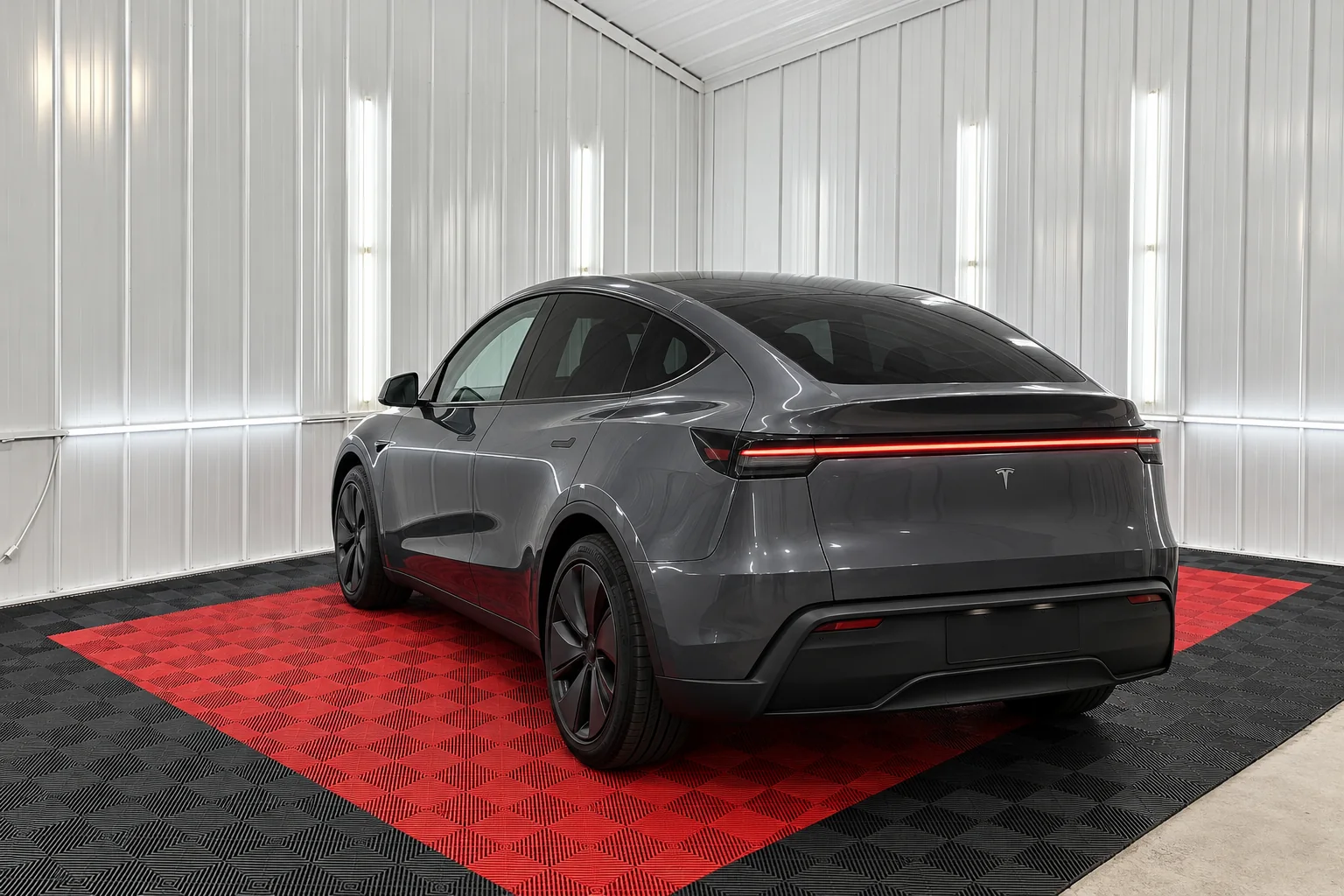 A black Tesla Model Y with tinted back glass in the OnPoint Tintz bay
