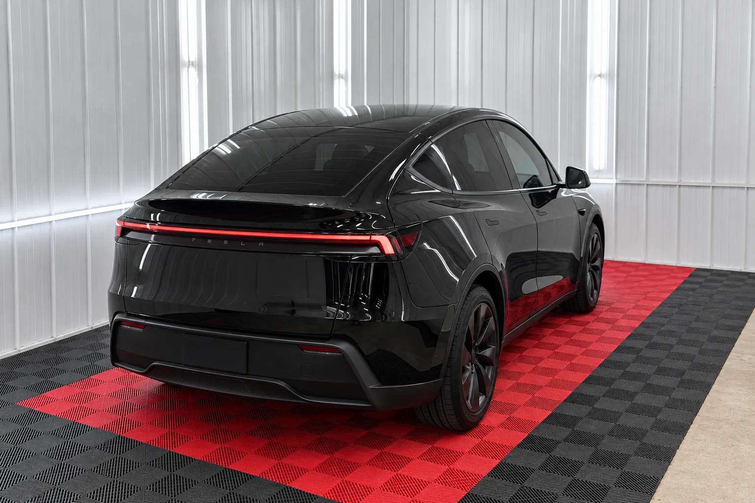 Gloss black Tesla Model Y Juniper with tinted windows at OnPoint Tintz